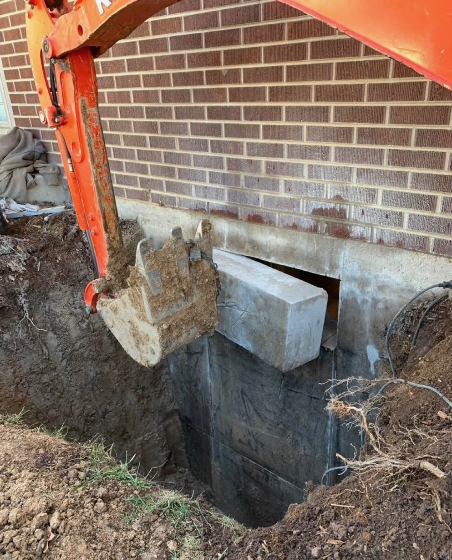 Egress window foundation cutting excavator Denver